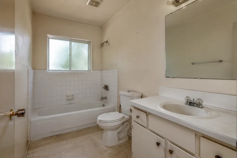 Plain dated bathroom before an AI redesign