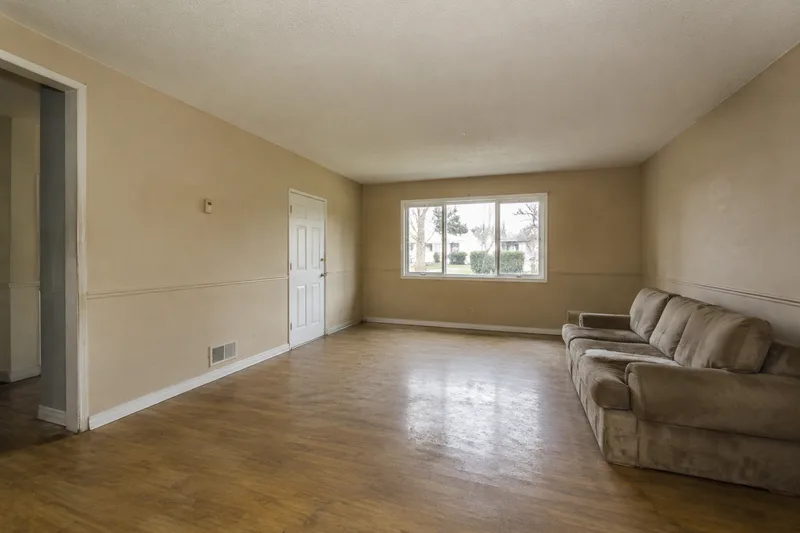 Plain dated living room before an AI redesign